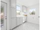 This is a bright laundry room with white cabinets, mosaic floors, lots of natural light, and a door to the outside at 3499 43Rd N St, St Petersburg, FL 33713