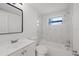 Updated bathroom with white vanity, bathtub, and marble-look tile at 3547 Garfield Dr, Holiday, FL 34691