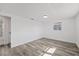 Bright bedroom featuring light grey wood-look flooring at 3547 Garfield Dr, Holiday, FL 34691