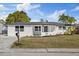 Newly renovated home with white brick exterior and landscaping at 3547 Garfield Dr, Holiday, FL 34691