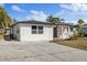 White brick house with gray roof and landscaping at 3547 Garfield Dr, Holiday, FL 34691