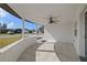 Covered front porch with ceiling fan and tile flooring at 3547 Garfield Dr, Holiday, FL 34691