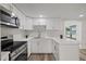 White kitchen with quartz countertops and stainless steel appliances at 3547 Garfield Dr, Holiday, FL 34691