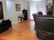 Living room with hardwood floors and leather furniture at 3829 Biscay Pl, Land O Lakes, FL 34639