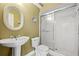 Small bathroom featuring a pedestal sink, toilet and shower with sliding glass doors at 3903 Sand Dollar Pl, Tampa, FL 33634