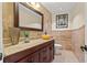 Half-bath featuring vessel sink, elegant fixtures, and travertine accent walls at 3903 Sand Dollar Pl, Tampa, FL 33634