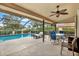 Covered lanai offering a perfect outdoor space with a pool and dining set at 393 Waterford E Cir, Tarpon Springs, FL 34688