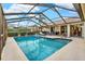 Spacious lanai with screened-in pool and outdoor seating area at 393 Waterford E Cir, Tarpon Springs, FL 34688