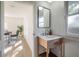 Modern bathroom with wood vanity, floating sink, and mirror at 409 E Adalee St, Tampa, FL 33603