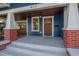 Attractive front porch with wood door and brick columns at 409 E Adalee St, Tampa, FL 33603