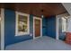 Covered porch with wood door and brick columns at 409 E Adalee St, Tampa, FL 33603