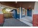 Covered porch with brick columns and a wood front door at 409 E Adalee St, Tampa, FL 33603