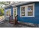 Charming blue house with a wooden front porch and steps at 409 E Adalee St, Tampa, FL 33603