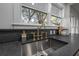 Modern kitchen sink with gold faucet and dark countertop at 409 E Adalee St, Tampa, FL 33603