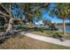 Curving concrete pathway winds through a park with mature trees and a lake at 409 E Adalee St, Tampa, FL 33603