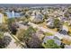 Aerial view of homes in a well-established neighborhood with mature trees and a scenic lake at 4210 Revere Cir, New Port Richey, FL 34653