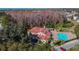 Beautiful aerial view of a large building with a swimming pool and surrounding trees at 4210 Revere Cir, New Port Richey, FL 34653