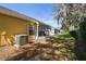 Backyard of home with screened-in porch with view of neighboring homes at 4210 Revere Cir, New Port Richey, FL 34653