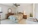 Cozy bedroom with wood furnishings, ceiling fan, and patterned bedspread at 4210 Revere Cir, New Port Richey, FL 34653