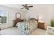 Comfortable bedroom with ceiling fan, wood furniture, and patterned bedspread at 4210 Revere Cir, New Port Richey, FL 34653