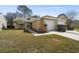 Charming single-story home featuring attached garages and well-maintained lawn in a tranquil neighborhood at 4210 Revere Cir, New Port Richey, FL 34653