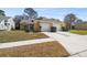 Inviting home exterior with a lush lawn, attached garage, and manicured landscaping at 4210 Revere Cir, New Port Richey, FL 34653