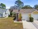 Charming home featuring a well-manicured lawn, attached garage, and inviting curb appeal at 4210 Revere Cir, New Port Richey, FL 34653