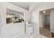 Hallway features a tiled floor and a view of the kitchen and main living area at 4210 Revere Cir, New Port Richey, FL 34653