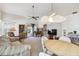 Living room with vaulted ceiling, ceiling fan, dining table and access to a sun room at 4210 Revere Cir, New Port Richey, FL 34653