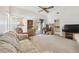 Cozy living room featuring a vaulted ceiling, sliding glass doors to a sun room and comfortable seating at 4210 Revere Cir, New Port Richey, FL 34653