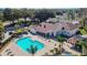 Aerial view of community pool area with spacious sun deck, lounge chairs, and a spa at 4210 Revere Cir, New Port Richey, FL 34653