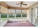 Enclosed sunroom with windows, a ceiling fan, and outdoor views of the surrounding yard at 4210 Revere Cir, New Port Richey, FL 34653