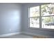 Bright bedroom featuring large window and wood-look floors at 4645 Commodore Ave, Spring Hill, FL 34606