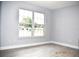 Bright living room with a large window, hardwood floors, and light gray walls at 4645 Commodore Ave, Spring Hill, FL 34606