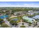 Aerial view of community with pool, tennis courts, and lush landscaping at 4802 51St W St # 224, Bradenton, FL 34210