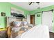 Main bedroom with barn door, ceiling fan, and a large window at 4802 51St W St # 224, Bradenton, FL 34210