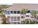 Two-story building with balconies and palm trees at 4802 51St W St # 224, Bradenton, FL 34210