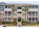 Tan condo building with balconies and palm trees at 4802 51St W St # 224, Bradenton, FL 34210