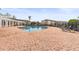 Community pool with lounge chairs and brick pavers at 4802 51St W St # 224, Bradenton, FL 34210