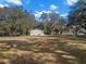 Spacious backyard with large trees surrounding home at 5104 Nesmith Rd, Plant City, FL 33567