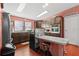 Kitchen features dark wood cabinets and a breakfast bar at 5104 Nesmith Rd, Plant City, FL 33567