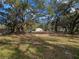 Spacious yard with mature oak trees and a mobile home in the background at 5104 Nesmith Rd, Plant City, FL 33567