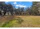 Large grassy yard surrounded by mature oak trees at 5104 Nesmith Rd, Plant City, FL 33567