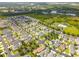 Aerial view of a residential community with a lake and lush greenery at 5200 Suncatcher Dr, Wesley Chapel, FL 33545