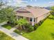 Aerial view of a charming one-story house with a peach-colored exterior and nicely landscaped yard at 5200 Suncatcher Dr, Wesley Chapel, FL 33545