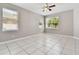 Spacious bedroom with tile flooring and multiple windows at 5200 Suncatcher Dr, Wesley Chapel, FL 33545