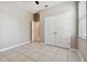 Bedroom with double door closet and tile flooring at 5200 Suncatcher Dr, Wesley Chapel, FL 33545