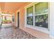 Front porch with tiled floor and a swing, offering a relaxing outdoor space at 5200 Suncatcher Dr, Wesley Chapel, FL 33545