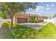 Attached garage with brown door and side yard access at 5200 Suncatcher Dr, Wesley Chapel, FL 33545