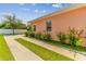 Side yard with concrete pathway and lush landscaping at 5200 Suncatcher Dr, Wesley Chapel, FL 33545